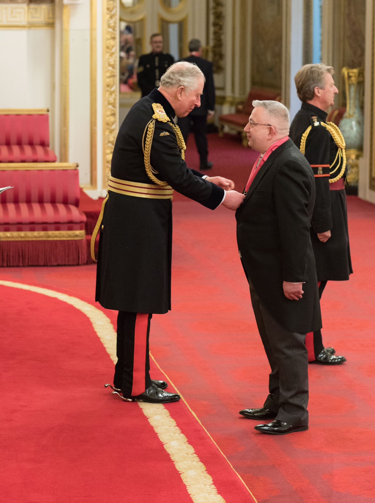 Duncan being presented with CBE